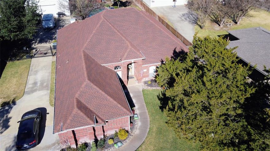 Take a look at this beautiful custom built, one owner, totally move in ready home on a huge well cared for and landscaped property, you will be very glad you did. There is lots of space for everyone in this home. Whether you enjoy the open floorplan in the family room or the patio and pool are more your style you will find a space you love. This 4 bedroom, 3 bathroom home has many custom feature throughout that will make your families life much happier and easier. All off the rooms have plenty of natural light in addition to the recessed lighting in many of them. Start your day in this wonderful kitchen and breakfast area with everything stored away but handy to get to in the many custom cabinets and pantry spaces.  Your personal space is the Primary wing of the home with lots of room and with extra sound barrier in the walls you will get the quiet you want. The large well equipped en suite bath and walk in closet finish off what will be one of the favorite parts of home for you. The other three bedrooms are all good sized and have large closets. Coming home you pull into the driveway and enter through the side garage to take your packages and groceries straight into the utility part of the home. While you were pulling into the driveway did you notice the 30ft x 40ft metal building for you to do anything you want with. Man cave or she shed, no way, this is a MANsion or She Shop. Lots of parking for your vehicles and toys behind the gate. Now to get to a highlight of this property. The pool and patio are without a doubt the place where family and friends will feel welcome and loved on those beautiful Texas days and nights that they are invited to join your daily fun. In addition to all of this not only does this home sit in the heart of DFW with everything you want to do within minutes this street is one of the most desired in Grand Prairie. Homes rarely come up for sale on this block and go fast when they do! Let your agent know you want to see it today!