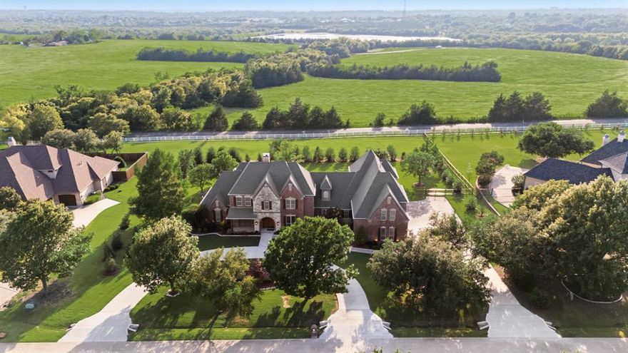 Stunning 1.5 Acre Estate welcomes you with a grand circle drive and elegant curb appeal.  Thoughtfully remodeled, the home features an expansive family room with stone fireplace that seamlessly flows into the informal dining area with custom built-in dish cupboard highlighted by a wall of windows with classic plantation shutters inviting natural light throughout.  The chefs kitchen has stainless appliances including a dual gas range, quartz countertops, lots of cabinet storage and a huge walk in pantry complemented by a spacious butlers pantry with built-in ice machine, perfect for entertaining.  The beautiful primary suite has a spa inspired bath with free standing soaking tub, a frameless glass shower, dual vanities and two spacious walk-in closets for optimal organization and luxury.  Additional amenities include designer style lighting, ceiling fans, hardware and fixtures along with an oversized laundry room which offers abundant storage with extensive cabinetry, generous counter space and a designated area for an additional refrigerator or freezer.  This luxurious home has dual staircases, a game room with built-in cabinets and bookshelves, and a separate wing with a bonus room and large bedroom with custom bath, a perfect option for an in-law suite with living space.  There is also an expansive covered patio with electric shades, an oversized 4 car garage with epoxy floors and 800 SQ. FT. of decked attic storage