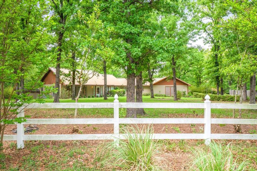 Perfect for family living and entertaining, this property sits on 10+ acres with an open floor plan offering scenic views from multiple angles. The kitchen features double ovens, island with cooktop, breakfast bar, separate breakfast area, walk in pantry and a separate formal dining area. Spacious primary suite plus a second bedroom that could serve as a private secondary suite. Third bedroom offers flexibility and could also be used as a home office. Enjoy the outdoors on the wraparound deck ideal for entertaining or relaxing while taking in the natural setting with deer and other wildlife. Additional features include a storm shelter in the back yard, RV parking and a building on the right side of the property. Workshop offers approx. 1,400 SF enclosed with electric on slab, plus approx. 1,100 SF carport. Property serviced by well water and conventional septic. Seller-owned solar panels provide added efficiency. Upgrades include engineered wood flooring and a metal roof. Property needs some TLC and is being sold AS IS. Great opportunity with endless potential.