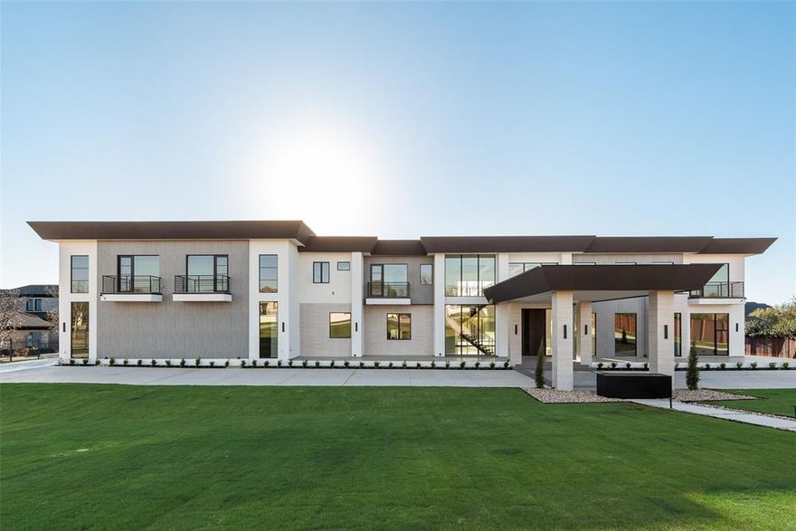Nestled on 2.46 acres off Southlake’s iconic, tree-lined White Chapel Blvd, this extraordinary east-facing gated estate blends modern design with unmatched luxury & boasts 8 bedrooms & 11 bathrooms. A grand circular drive & porte cochere set the stage for unforgettable arrivals, while the dramatic cantilevered entry door welcomes you into a light-filled interior. Designed to impress, the great room features soaring ceilings & a stunning colored water mist fireplace made of natural stone with 130 inch video wall system. The dining room showcases temp-controlled wine storage, while the showpiece kitchen boasts a large island, natural stone counters, Wolf 6-burner induction cooktop, double Wolf ovens, built-in Thermador refrigerator-freezer & fully automated Miele coffee maker. A fully equipped prep kitchen offers add'l appliances, walk-in pantry & breakfast area. The owner’s suite is complete with double-sided water mist fireplace & spa-inspired bath featuring a freestanding tub, walk-in shower with dual heads, 2 private water closets & custom walk-in closet. The main home offers 7 spacious bedrooms, each with its own ensuite, custom closet & private patio or balcony access. 3 bedrooms, including the primary & a jr suite, are located down, with a jr suite & 3 add'l bedrooms up. A charming guest house completes the estate with full kitchen, living, bedroom & bath—ideal for guests or multigenerational living. Accessible by elevator, the upstairs has a game room with wet bar, media room, exercise room & multiple balconies overlooking the property. A 2nd laundry upstairs adds convenience. The resort-style backyard features a sparkling pool & spa, covered patio with gas fireplace, outdoor kitchen with Artisan appliances, fire pit & outdoor shower. Add'l highlights include 1,400 SF of unfinished space, 4-car garage with metallic epoxy floor, pet washing station & pre-wiring for window shades. This is luxury living at its finest in one of Southlake’s most coveted locations!