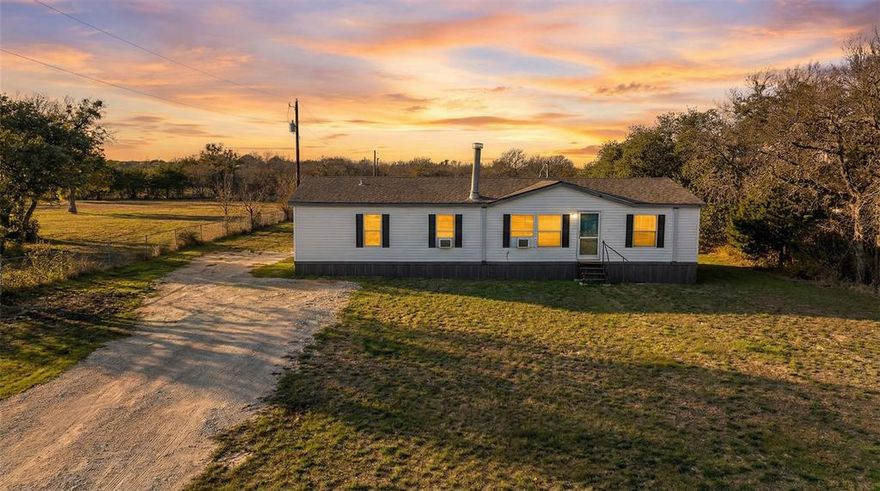 Enjoy peaceful country living in this spacious and well-maintained 3-bedroom, 2-bathroom mobile home situated on 2.3 beautiful acres. This clean and move-in ready home offers an inviting layout with thoughtful updates throughout, including updated flooring and modern fixtures that give the space a fresh, comfortable feel. The secondary bathroom has been completely renovated, adding both style and functionality. Each bedroom offers generous space, while the open living areas provide the perfect setting for relaxing or entertaining. Step outside and take in the wide-open 2.3 acres — ideal for gardening, animals, outdoor entertaining, or simply enjoying the quiet surroundings. With plenty of room to roam and endless possibilities, this property offers the freedom and flexibility of true country living while still being within reach of town conveniences. Home is not real property and has been moved twice. Listing agent is related to seller. Survey is available on MLS. Being sold as is where is. Property has lender information attached to documents for special financing if needed. Plug in 191 Yucca View East into GPS and then turn onto Cross Timbers and house will be on your left, sign out front. Survey in under supplements for better reference.