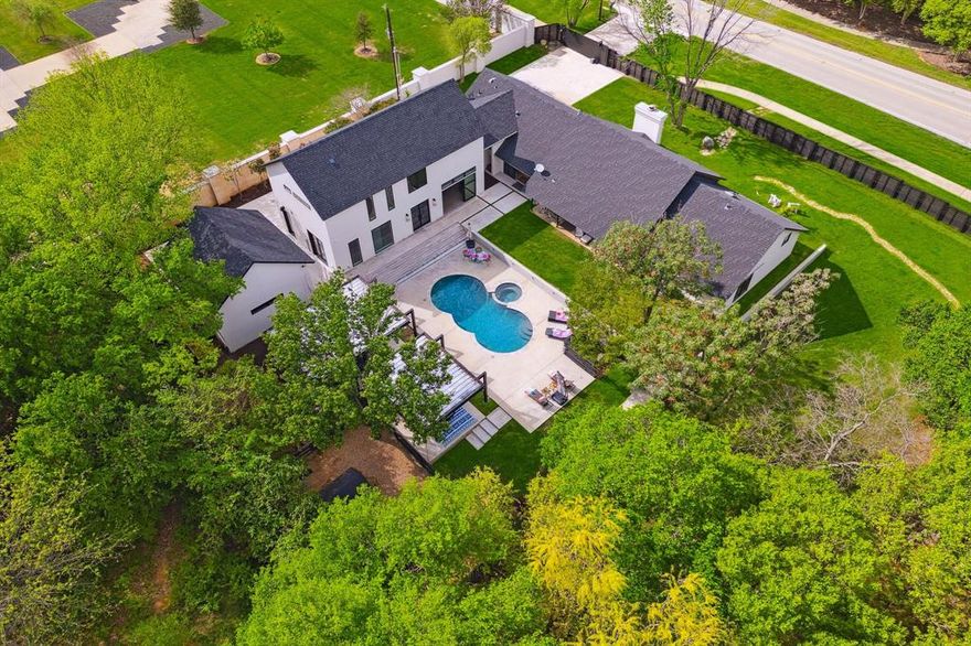 Nestled on a 1 acre lot in Southlake, 2 minutes from Town Center. Originally built in 1983 and fully renovated and expanded in 2016, w. another major expansion in 2023, this residence offers 5 beds, 5 baths, office (could be used as media room), and 2 bonus rooms. House wired w. 5.1 speakers.
The interior features 2 dining and 2 living areas and gourmet kitchen w. high-end appliances and custom finishes. Your private retreat suite boasts a spa-like bathroom and oversized closet.
Outside, a double patio w. an outdoor kitchen w. grill, fridge, sink, storage and space for green egg, and custom-designed dog houses. A romantic creek runs through the property w. a bridge.
Additional features include a two-car detached garage w. bonus room upstairs and another bonus room on the way to the garage, currently used as gym.
Home offers a perfect blend of traditional charm and European contemporary amenities, providing unparalleled lifestyle.
