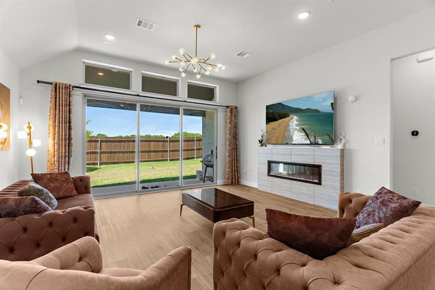 Discover this stunning 4-bedroom, 3-bathroom home in The Villages of Hurricane Creek, one of Anna’s most sought-after communities. Offering over 2,100 sq. ft. of beautifully designed living space, this residence seamlessly blends everyday comfort with timeless style. Step inside to soaring ceilings, abundant natural light, and two versatile living areas perfect for a second family room, game room, or home office. A cozy electric fireplace adds warmth and charm, creating an inviting space to relax or gather. The open-concept layout flows into the dining area and the heart of the home a modern kitchen with sleek finishes, ample cabinetry, and views of the backyard. Patio sliding doors extend your living space outdoors to a private retreat ideal for morning coffee, summer BBQs, or unwinding under the stars. Four generously sized bedrooms, including a luxurious primary suite with a spa-like bath with large soaking tub and separate shower, offer plenty of room for everyone. With three full bathrooms, convenience and comfort are built right in. Beyond the home, The Villages of Hurricane Creek provides exceptional amenities including an amenity center, trails, creeks, ponds, open green space, and scenic lookouts. Located just minutes from Hwy 75 and quick access to shopping, dining, and top-rated Anna ISD schools, this community offers the best of both worlds, a peaceful suburban lifestyle with city amenities close by.