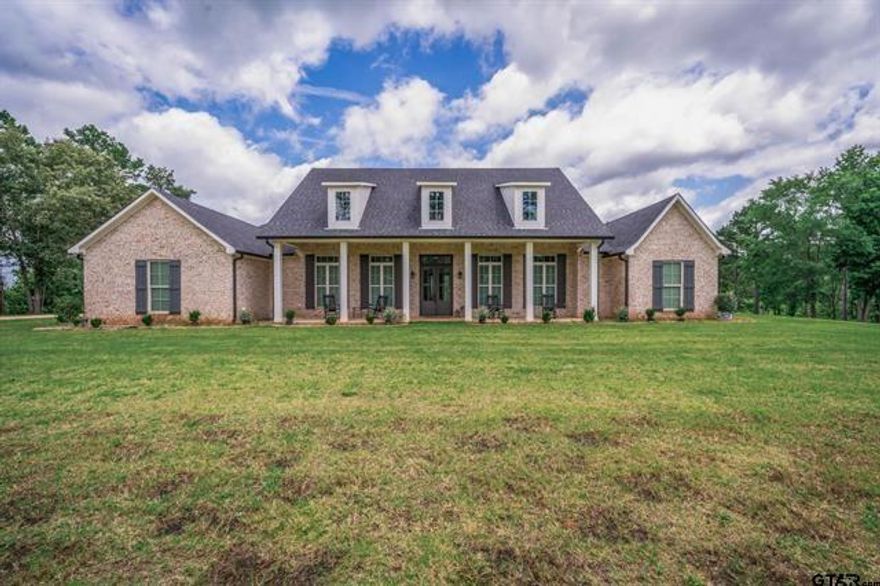 Experience the perfect blend of modern comfort and serene country living with this stunning custom built home, completed in 2022 and nestled on 35 unrestricted acres in the heart of East Texas. This 1.5 story residence offers 4 bedrooms, 3 full bathrooms, and a thoughtfully designed layout ideal for both family living and entertaining. The open concept living area features a seamless flow into the chef-inspired kitchen, complete with stainless steel appliances, a large center island with bar seating, butler's pantry with ample storage, additional counter space, secondary refrigerator, and sink. Natural light floods the space, creating a warm and inviting atmosphere. Retreat to the luxurious primary suite, where you’ll find a spa like ensuite bath with double vanities, a private water closet, an oversized shower with dual shower heads, and a deep soaking tub perfect for unwinding. The walk in closet is generously sized and includes custom built ins for organization and ease. A half story loft sits above the two car carport, currently used as a second living room and home office; offering flexible space to meet your needs, whether for work or play. Outside, the expansive 35 acre tract offers endless opportunities for recreation, agriculture, or simply enjoying the peace and privacy of wide open spaces. Whether you're looking to homestead, hunt, or just relax under the Texas sky, this property delivers. Don’t miss this rare opportunity to own a turnkey home with acreage; the perfect combination of style, functionality, and natural beauty.