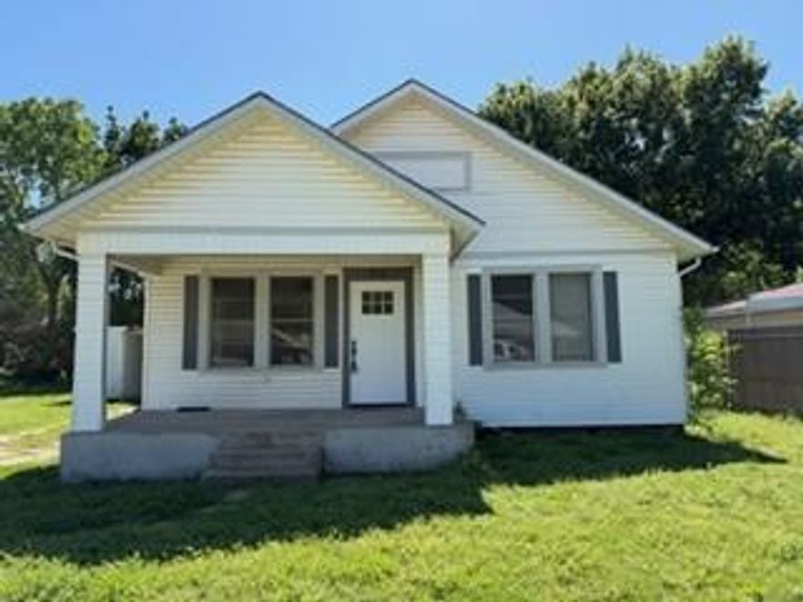 This charming cottage offers tasteful updates and a cozy vibe. Featuring 2 bedrooms and 1 bath, it’s perfect for a starter home, singles, or a small family. Move-in ready with stainless steel appliances, marble countertops, a walk-in shower, and plenty of storage. Features a separate utility room with entrance to backyard. There’s a carport with an attached storage room, and the backyard is fully privacy fenced. Sitting on one side of two lots, there’s ample space for extra yard, a shop, or more. The covered front porch is ideal for plant lovers or simply relaxing in the shade.