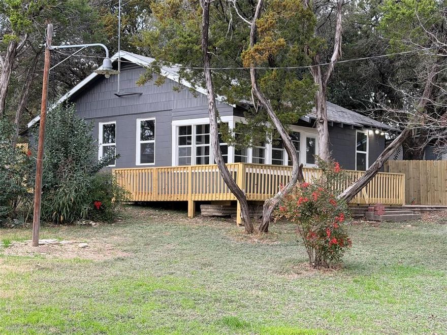 Perfect small lake house very close to Whitney Ridge Marina.    Remodeled, with nice flooring, very nice kitchen, 2 small bedrooms, den and dining area open together.    Enclosed front porch.   New deck on the front and one side of the house.   Small back yard with a privacy fence makes it a perfect little area with plenty of privacy.    Brand new roof installed recently.

The lot is a huge corner pie shaped property.   Lot's of potential with this property.    

This property is across CR 1700 from Mr K's store.