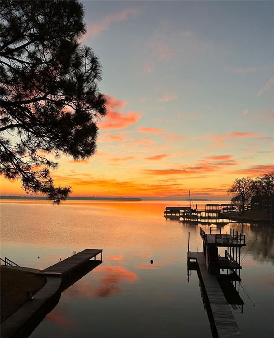 Welcome to your dream lakefront retreat! This beautifully updated two-story home in the gated community of Heatherwoods offers the perfect blend of comfort, elegance, and breathtaking views of Cedar Creek Lake. Featuring 4 spacious bedrooms, 2.5 beautifully remodeled bathrooms, and 2,530 square feet of open-concept living space, this home was designed for lake living and entertaining. The home has two fireplaces; one in the living room and one in the primary bedroom. Step inside to find brand-new flooring throughout, a custom mantelpiece, and a bright, open floor plan that flows seamlessly to a wet bar and stunning outdoor spaces. Enjoy your morning coffee from porches overlooking the water—both upstairs and downstairs. The upstairs porch is accessible from two of the bedrooms. The property’s two-story boathouse with a new walkway provides easy lake access for boating, fishing, or simply soaking in the views. Water depth is about 8 ft at the end of the dock and 3 - 4 ft near the seawall. This provides a protected swimming area. This exceptional home has been thoughtfully cared for and updated, offering a perfect balance of lakeside relaxation and modern style. Comes fully furnished and move in ready. Whether you’re looking for a weekend escape or a full-time residence, this waterfront gem is ready to be your next chapter.