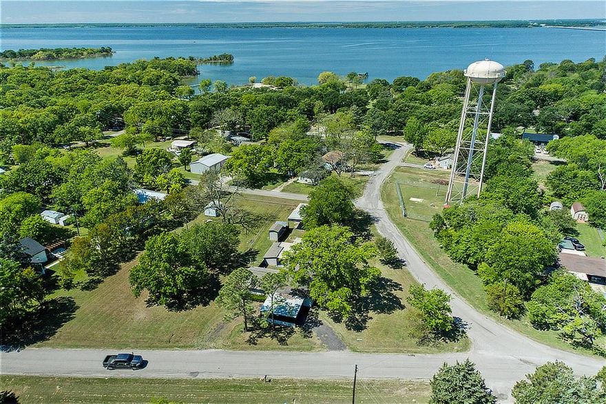EXPERIENCE THE ULTIMATE LAKESIDE LIFESTYLE IN THIS STUNNINGLY REMODELED RESIDENCE POSITIONED IN THE RENOWNED CATFISH CAPITAL OF TEXAS. This property stands out with its rare combination of a nearly one-acre footprint and a prime location within walking distance to the lake and a public boat ramp just down the street. Inside, the renovation shines through a contemporary open-concept layout where a massive white-washed brick fireplace adds warmth to the living space and the kitchen offers an incredible amount of cabinetry for the organized home cook. The true value of this estate lies in its incredible infrastructure, specifically the massive metal building and workshop that features drive-through industrial doors to accommodate the largest of projects or recreational vehicles. The backyard is an entertainer’s paradise, centered around a large covered patio and firepit area that is perfectly situated for future outdoor kitchen expansion. Anglers will appreciate the dedicated fish cleaning station with integrated plumbing, ensuring the transition from lake to table is as smooth as possible. With the added potential to acquire two neighboring half-acre lots, this is a unique investment opportunity for those wanting to secure a significant footprint in East Tawakoni. From the oversized workshop to the meticulous interior finishes, every inch of this property is designed to enhance your enjoyment of the Lake Tawakoni area.