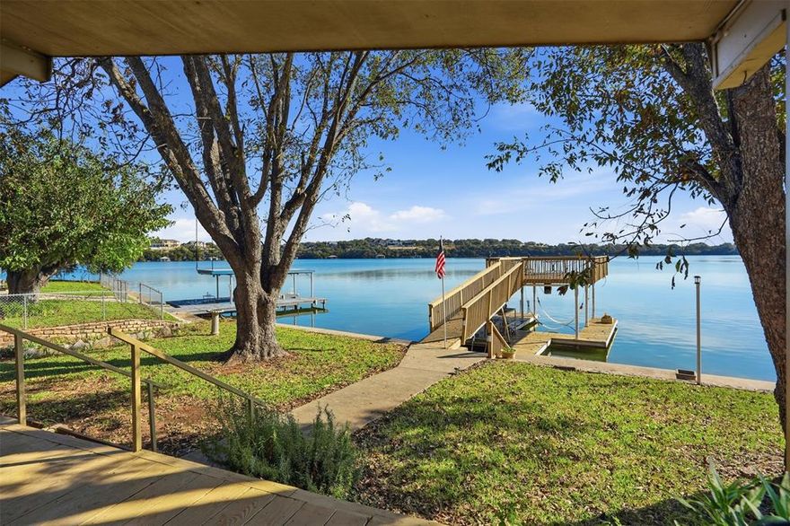Enjoy peaceful waterfront living at 4016 Linda Court in Granbury, a charming 2-bedroom, 2-bath lakefront home offering 1,372 square feet of comfortable space and incredible views of Granbury Lake. Tucked inside a gated community with security, this property provides the perfect blend of relaxation, recreation, and privacy.

Step inside to a warm and inviting living room featuring a fireplace, wood-beam ceilings, and a stunning wall of windows that frame breathtaking lake views and fill the space with natural light. The kitchen is well-equipped with a gas range and an abundance of cabinets, making it both functional and welcoming for everyday cooking or entertaining.

The home includes a spacious primary bedroom with an ensuite bath featuring a garden tub and separate shower, while the full guest bath serves the second bedroom and visitors. A utility room with sink and ample cabinetry adds convenience and extra storage.

Outdoor living is where this property truly shines. A huge rear porch overlooking Granbury Lake offers the perfect spot for morning coffee, sunset views, and entertaining guests. For lake enthusiasts, the property includes a two-story boat dock with a new lift, providing easy access to the water and plenty of space to relax by the lake.

Additional improvements include an oversized detached garage, carport for extra parking, greenhouse, and storage shed, giving you room for hobbies, tools, and recreational gear.

Whether you’re looking for a full-time residence or a weekend lake retreat, this waterfront gem delivers spectacular views, private lake access, and a serene lifestyle in one of Granbury’s desirable gated communities.