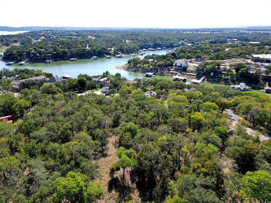 APPROXIMATELY 110 FT OF GORGEOUS OPEN WATERFRONT SLOUGH LOT IN THE HIGHLY SOUGHT AFTER RESORT COMMUNITY OF JACKSON RANCH, THREE FINGERS COVES, LOCATED ON THE NORTH END OF LAKE BRIDGEPORT*ENJOY FISHING,BOATING & ENTERTAINING*PEACEFUL, PRIVATE LOT W HUNDREDS OF MATURE TREES & NATURAL ROCK LANDSCAPING*THIS WOULD MAKE A GREAT AIR B & B*2 LOTS ACROSS THE STREET ARE ALSO AVAILABLE, SOLD SEPARATELY*THE EXTRA LOTS WOULD MAKE A GREAT POOL, SHOP OR GUEST HOUSE*HOME RECENTLY APPRAISED BY KYLE HERTEL FOR $625,000, SEE TRANSACTION DESK FOR APPRAISAL*2 BOAT DOCKS, ONE WITH A HYDO HOIST BOAT LIFT AND THE OTHER STRUCTURE SERVES AS A PERGOLA TO GET OUT OF THE SUN AND ENTERTAIN*PARTY LIGHTS CONVEY*46 LONG WALKBOARD TO DOCKS*PROPERTY WOULD MAKE A GREAT HOME OR VACATION HOME*FEEL THE GENTLE BREEZE OFF THE LAKE FROM THE MULTI TIERED 24 X 27 WOOD DECK! ALL WATER PROVIDED FROM THE LAKE*PUMP HOUSE PUMPS WATER FROM LAKE, FILTERING SYSTEM IN PLACE, FILTER REPLACED 2024*SOME OUTSIDE FURNITURE CONVEYS (NOT THE POWDER COATED TABLE & CHAIRS),GOLF CART,2 AREA RUGS,2 SMOKERS,GAS GRILL,SOME TOOLS,KITCHEN TABLE & CHAIRS,ALL WINDOW COVERS CONVEY*WASHER & DRYER CONVEY W ACCEPTABLE OFFER*ALL CEILINGS HAVE BEAD BOARD,VAULTED CEILINGS,BLINDS THROUGHOUT,TILT OUT WINDOWS INSTALLED 2007*HVAC REPLACED 2017*FLOORING REPLACED 2021*WATER HEATER REPLACED 2024*RURAL FEEL*ESCAPE TO COUNTRY AND THE WATER! WISE COUNTY CO OP FOR ELECTRICITY*WILDLIFE ABOUNDS, DEER FREQUENT THE PROPERTY*3 BEDROOM*2 BATHS*2 LIVING*1 DINING*2 CAR CARPORT*HOME SITUATED HIGH ON A HILL WITH A SLOPING LOT FROM THE HOME TO THE WATER*LONG ASPHALT DRIVEWAY LEADING TO HOME*GREENHOUSE CONVEYS*LVP & CARPET FLOORING*BEAD BOARD CEILINGS THROUGHOUT*2 SIDED FIREPLACE IN LIVING,OPEN TO KITCHEN W GRANITE COUNTERS,LOVELY CABINETRY, STAINLESS APPLIANCES & ISLAND W STORAGE*CABINETRY RECENTLY RESTAINED*2ND DINING OR 2ND LIVING HAS BUILT IN HUTCH*1.5 HR DRIVE TO DFW AIRPORT*SEE AMENITIES & FEATURES LIST, 360 TOUR, DRONE VIDEO AND FLOOR PLANS ON NTREIS*