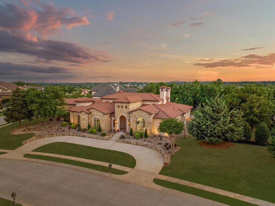 Nestled on an expansive .95 corner lot, this exceptional ONE-STORY estate offers refined living in the prestigious, guard-gated community of Granada. With 4 spacious bedrooms, a  4-car garage, and thoughtfully designed living spaces, this home blends elegance with everyday functionality. The heart of the home is an impressive great room with soaring 22' vaulted ceilings, flowing effortlessly into a show-stopping chef’s kitchen featuring Wolf and Sub-Zero appliances, a Taj Mahal quartzite island, and Calcutta Royal Quartz countertops. A 1,500-bottle, temperature-controlled wine cellar adds a sophisticated touch for the avid entertainer or collector. The serene Master suite features a luxurious spa-style bath with Calcutta marble, a private courtyard and his and her closets. A flexible bonus room serves perfectly as a home gym or second office.Outdoors, enjoy your own private resort-style oasis with a sparkling pool and spa, fire pit, covered lounge areas —ideal for year-round relaxation. Zoned to Westlake Academy or CISD. this estate offers the ultimate in privacy, prestige, and comfort in one of Westlake’s most sought-after neighborhoods.