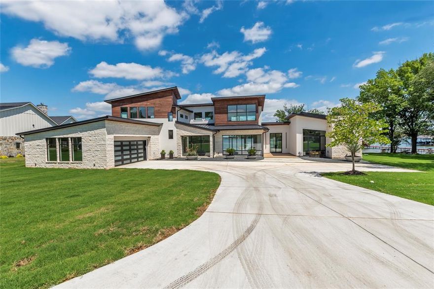 Custom, new construction home with Paradise views and deep water will captivate you from the moment you see it. Located in the desired Waterboard subdivision, this home offers over 5,500 sqft of luxury in every corner.Grand front entry way and iron door open into wall to wall windows with picturesque views. Right wing of home includes one bedroom and bathroom, and primary suite with lounge, oversized closet and magazine worthy bathroom. Private back patio off master bedroom. Left wing of home features study, dining, bar, media room, utility room, two bedrooms and 2.5 bathrooms. Upstairs has huge bunk loft with bathroom and closet. The outdoors may steal your heart and summer afternoons.Infinity pool with large hot tub overlooks the panoramic lake views. Several back porches to choose from. Enjoy your favorite beverage from the indoor-outdoor bar, cook at the outdoor kitchen, take a dip in the infinity pool or hot tub, or enjoy the oversized boat dock that is ready for you!