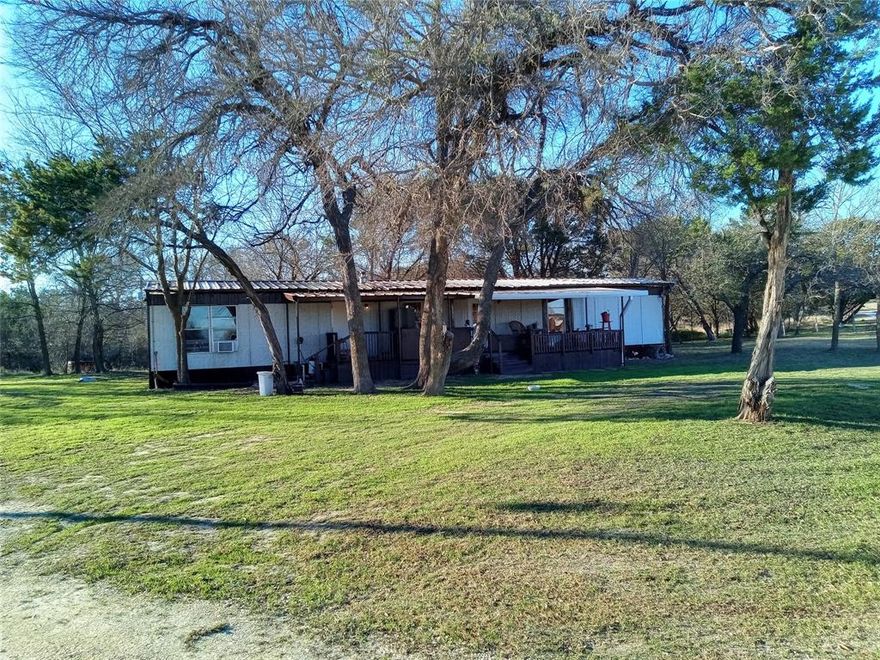 .99 acres in the country, fully furnished. Property includes manufactured home, two beds one and one half baths, barn with fireplace, dog kennel, fenced dog run, propane tank, water meter, septic tank, over 300 feet of gravel driveway. Turnkey, all inclusive, bring your suitcase and start living today. Washer and dryer, beds, bunks, table and chairs, lazy boy recliner, silverware, cups, plates, refrigerator, lamps, lightbulbs, etc... One of the best locations in the county, neighboring properties range from 575,000 - 1.2 million in evaluation. Additional property may be available if desired. Everything is sold with the property.