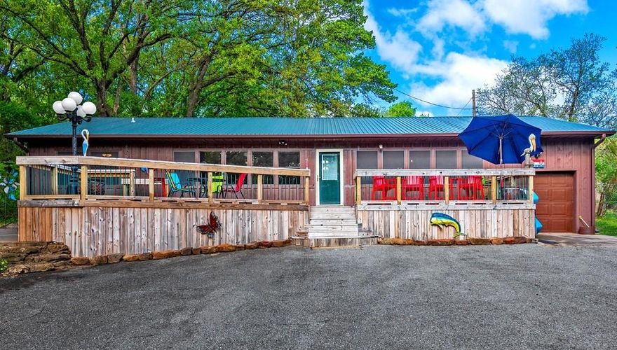 Beautiful Lake home with pretty mature shade trees and easy access in front of the home to Lake Texoma.  Home features modern updates and large master with bath, golf cart style garage, easy access to beach and a nice shared boat slip.  Sit and Sip on your own private deck and watch the boats, children and waves roll in.  Split bedroom arrangement, lots of storage and price includes boat slip and small storage building in back.  Joins USA land, no restrictions against VRBO's in the area.