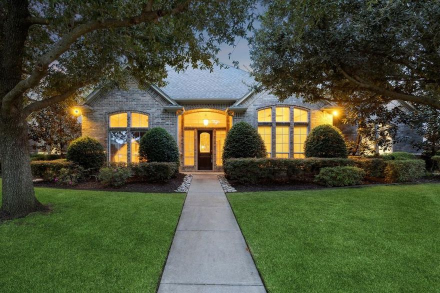 Welcome to this exquisite 4-bedroom residence that perfectly blends timeless elegance with comfortable luxury. Upon entry, a private study offers serene front-yard views, ideal for a quiet home office or library. The formal dining room exudes sophistication with a stunning chandelier and crown-molded ceilings, setting the stage for memorable gatherings. The inviting living room is a true showpiece—featuring rich plank hardwood floors, a tiered ceiling, a cozy fireplace, and custom built-ins that add both style and function. The Chef’s Kitchen is a culinary dream, showcasing gleaming granite countertops, a wraparound breakfast bar, abundant cabinetry, a center island, tumbled stone backsplash, gas cooktop, and easy-care tile flooring—perfect for both daily living and entertaining. The expansive primary suite is a private retreat, complete with dual vanities, a jetted soaking tub, a separate double shower, and an oversized walk-in closet. Additional guest bedrooms are generously sized, while a built-in workstation with dual desks provides the perfect space for homework or creative projects. The upstairs features two bedrooms, a game room plus an amazing bonus room! Step outside to your own backyard oasis featuring a covered patio overlooking a sparkling pool with a rock waterfall, an extended sun patio for lounging, and a lush grassy area ideal for play or relaxation. This home offers refined living at its finest—thoughtfully designed for both elegance and everyday comfort.