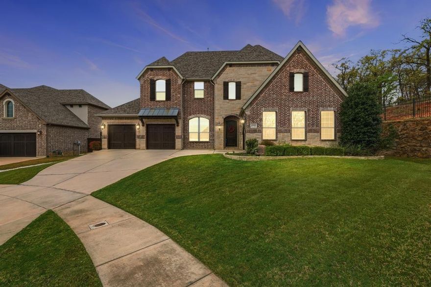 Experience unparalleled privacy in the heart of Canyon Falls. Perfectly positioned on a premium cul-de-sac lot, 6721 Oak Knoll Rd backs directly into a lush, protected greenbelt, offering a serene backdrop that is rare to find. This Drees Homes (Ravena layout) blends stately architecture with the tranquility of nature, providing a private sanctuary just steps away from world-class community amenities. A combination of architectural grandeur and true comfort.  The backyard is a white canvas, sized at .32 acres, perfectly sized for a resort-style pool, outdoor kitchen, or extra-large playground for kids and pets. Step through the grand foyer to discover a dramatic entrance with elegant chandeliers, double-height ceilings, hardwood flooring, and a private home office behind French doors and a downstairs guest bedroom. The family room exudes Timeless Elegance, featuring a cozy fireplace and Plantation Shutters throughout that bathe the home in soft, natural light. The heart of the home is the stunning kitchen—a chef’s dream featuring a massive, upper-grade granite island designed for both prep space and grand-scale entertainment. Tucked away for ultimate privacy, the Primary Retreat offers a spa-style bathroom with a clawfoot tub and a huge walk-in closet that conveniently connects directly to the laundry room. Upstairs, the Texas-sized layout continues with a split-plan featuring two en-suite bedrooms, a large loft, a separate media room, and a 5th bedroom currently transformed into a hot yoga and fitness studio. Permanent holiday jellyfish lighting included. Enjoy the unique topography of Canyon Falls—where the HOA includes front yard maintenance, cable, internet, and amenities like resort pools, a fitness center, and coming-soon pickleball courts. With the lower Flower Mound tax rate and top-rated Argyle ISD, this impactful home is the sophisticated, Timeless Organic upgrade your family has been waiting for!