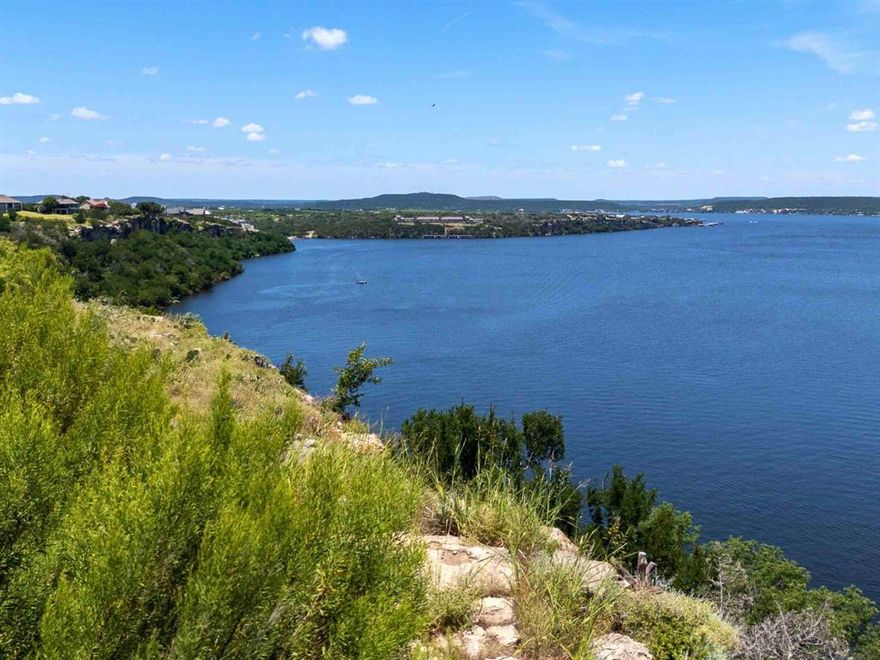 PANORAMIC LAKE FRONT VIEWS OF POSSUM KINGDOM LAKE!!  OWNER FINANCING AVAILABLE!!  Build your dream waterfront weekend getaway or full-time home on this stunning property perched high above the lake inside the prestigious Cliffs Resort community, boasting unparalleled panoramic views of Possum Kingdom Lake.  This premier location combines natural beauty with refined resort living. Enjoy tranquil evening walks to the nearby on-site restaurant, just a short distance away.  Surrounded by a championship golf course, this property is the ideal retreat for both golf enthusiasts and nature lovers alike.