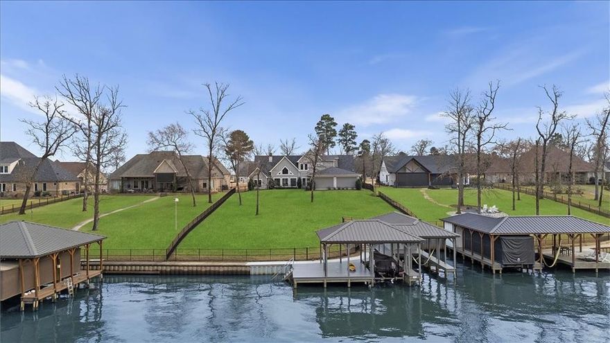 Welcome to a captivating waterfront oasis that exudes luxury living in the prestigious gated community of Browns Landing. This exquisite property features five spacious bedrooms and four and a half baths, alongside a theater room for cinematic escapism. Entering through elegant double glass pane wooden doors, you are greeted by vaulted ceilings in the open living area, adorned with rich wood floors and abundant cabinetry. The centerpiece of this inviting space is a stunning fireplace, complete with beautiful stonework that reaches up to the ceiling, creating a warm ambiance. The gourmet kitchen is a chef’s dream, featuring a large accent island, double ovens, a gas cooktop, a side-by-side refrigerator and freezer, and a walk-in pantry. The thoughtfully designed floor plan includes two guest bedrooms located near the entry, sharing a well-appointed Jack and Jill bathroom, with one currently utilized as an office. On the opposite side of the main level, the luxurious primary suite offers a serene retreat with a double vanity, soaking tub, walk-in shower, and expansive walk-in closet. Ascend the stairs to discover two additional bedrooms, each with their own en suite bathrooms, along with the impressive theater or bonus room that adds versatility to this magnificent estate. Venture outside to the covered patio, equipped with electric shades for optimal climate control, perfect for year-round enjoyment. Set against a beautifully manicured fenced backyard, complete with elegant wrought iron fencing, this outdoor space invites you to unwind on warm days or gather around the grill for delightful evening barbecues. Further enhancing this luxurious lifestyle are community amenities, including common areas, a security gate, a picnic pavilion with a fireplace, a waterfront fire pit, underground utilities, and a marina boat ramp. Residents enjoy access to a separate gated storage area for trailers, boats, and RVs. Embrace the lake living life on Lake Palestine!