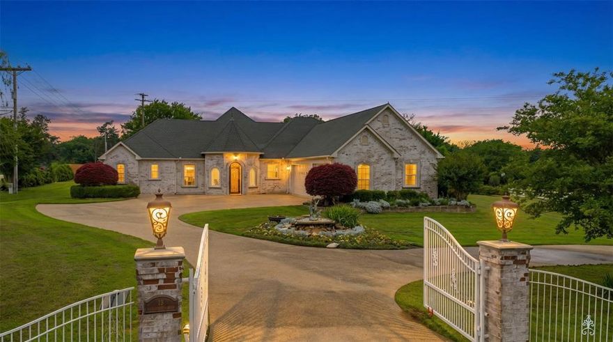 This impressive 2,725 sq ft corner estate sits on a beautifully landscaped, oversized lot designed for both privacy and elegance. A gated entrance with private electric access and a sweeping concrete circular driveway creates a grand first impression and enhances curb appeal.  The 36x23 three car garage protects your cars and toys.

Step inside through a striking decorative metal front door to a light-filled main living area featuring formal spaces ideal for hosting and everyday comfort. The open-concept design flows seamlessly into an oversized kitchen with a breakfast bar and two distinct dining areas—perfect for casual meals or formal gatherings. A spacious den offers an expansive area for relaxation or entertaining.

The luxurious 21x16 primary suite serves as a private retreat, complete with a 15x14 spa-like bath featuring a jetted tub, separate shower, and an impressive 15x14 walk-in closet. Generously sized secondary bedrooms, including a 20x16 room, provide flexibility for guests, office space, or hobbies.

Outdoor living is truly exceptional, with a covered patio equipped with automatic shades for comfort and a meticulously maintained yard ideal for hosting weddings, celebrations, or large gatherings. Multiple electric gates and abundant parking ensure convenience and security.

Blending refined indoor living with extraordinary outdoor space, this one-of-a-kind property offers a rare opportunity for those who love to entertain in style and remember the generator is always ready to keep any party going.