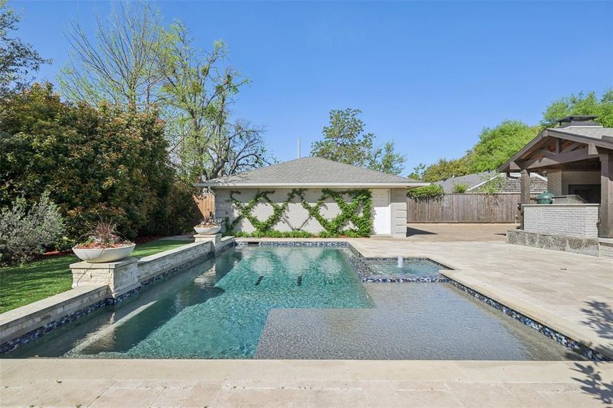 *Back on the market due to no fault of the property.* Stunning, thoughtfully designed open-concept home situated on a 120x150 foot lot in one of Dallas’ most sought-after neighborhoods. Built in 1956, this single-story home offers exceptional curb appeal, multiple entertaining spaces, and over 500 sqft of covered outdoor living. Off the entry, you’ll find a formal living rm and an inviting family rm featuring vaulted ceilings, custom built-ins, and a gas fireplace. These spaces flow seamlessly into the formal dining rm and a beautifully appointed chef’s kitchen. The kitchen is equipped with an expansive island, 2 dishwashers, built-in refrigerator, beverage refrigerator, double ovens, microwave, and an impressive walk-in pantry area with built-ins and a full-size wine refrigerator. An adjoining breakfast rm completes the space. Adjacent to the kitchen is a spacious game rm with built-ins and a full bath—ideal for entertaining or flexible living. The private primary suite is tucked at the rear of the home, offering serene views of the sparkling pool, plus a generous WI closet. The luxurious primary bath features high-end marble finishes, dual vanities, a jetted tub, and a sep shower. 2 secondary bedrooms, both with WI closets, share a Jack-and-Jill bath, while a 3rd bedroom enjoys access to a full, hall bath. A large utility rm, complete with built-ins and a sink, rounds out the interior of this home. The backyard is an entertainer’s dream, showcasing multiple seating areas, motorized screens, built-in grill, Green Egg cooker, beverage refrigerator, TV, and a wood-burning fireplace. The outdoor living space overlooks the resort-style pool with spa and water feature, along with a generously sized turfed yard. Addl highlights: Sonos speakers in the kitchen, primary bedroom, and patio; oversized 24x27 garage with workspace and storage; a gated driveway; and exterior security cameras. Ideally located near Preston Royal shopping & dining with quick access to the Tollway.