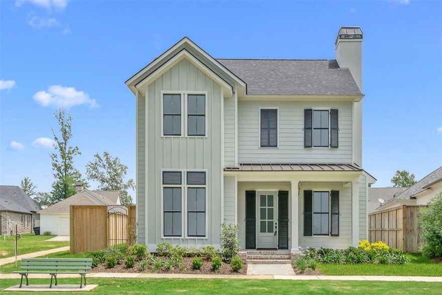 Beautiful home on Greenleaf Park in Provenance, a naturally preserved semi-circle-shaped park surrounded by custom homes and well known for its many community events. The open floor plan is perfect for everyday living as well as entertaining, and the charming front porch welcomes guests with southern appeal. The nearby dedicated parking areas around the park also make hosting guests convenient. The Living Room features a cozy fireplace adding warmth and character to the main level. The Formal Dining space with chandelier sits gracefully between the Kitchen and Living Room creating a seamless flow ideal for gatherings. The Chef’s Kitchen includes a 6-burner gas range, custom vent hood, spacious pantry, to-the-ceiling cabinetry, leathered granite countertops, an oversized island with seating and storage, stainless steel appliances, a water spigot and farm sink. Wet Bar conveniently located off the Kitchen and patio. Three sets of beautiful French doors open to an oversized outdoor patio with a wood ceiling complete with an outdoor kitchen (attached grill, prep space, sink) fans & lighting. The yard is fully fenced. A secluded Master Suite offers a luxurious retreat with double sinks, marble-like tile, quartz countertops, a soaker tub with jets and an oversized walk-in shower. Additional main-level features include a downstairs Guest Suite, oversized Laundry Room with sink and a great drop area off the garage with a Mud Bench. Upstairs, you’ll find a spacious landing perfect for an Office or kids’ playroom along with 3 spacious Bedrooms and a full Bathroom featuring hexagon tile. Beautiful wood flooring spans the main level and plantation shutters are found throughout the home. Walk or ride a golf cart to Rhino Coffee, restaurants, bank, post office and community events. Enjoy the Provenance lifestyle with access to the neighborhood pool, parks, clubhouse and gym.