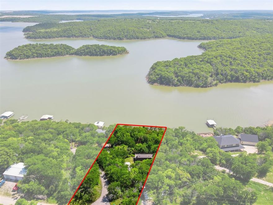 Investor special on Lake Bridgeport! Situated on a treed, nearly half-acre lot with direct lake access, this property offers exceptional potential for renovation, resale, or short-term rental income.  The existing cottage is in need of updates, making it an ideal value add opportunity for investors looking to maximize returns. Property features include a wraparound covered porch and a private dock, highly desirable amenities for vacationers and weekend renters.  With its prime lakefront location and strong demand for waterfront properties, this is a rare chance to transform a fixer upper into a high performing income producing asset. Plenty of room to enhance, expand, or rebuild to capture full market value.  Bring your vision and unlock the potential this Lake Bridgeport property has to offer!