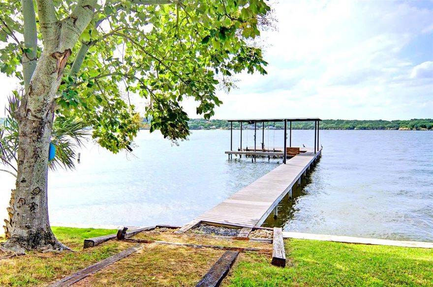 Welcome to this fabulous main body waterfront property with deep water, panoramic views, and incredible sunsets. This private oasis is situated at the end of a quiet cul-de-sac featuring mature trees and beautiful landscaping. This property is not included in a HOA and is outside the city limits allowing for unrestricted enjoyment of this incredible lake Granbury retreat. Enjoy the bunk house and pavilion featuring a full outdoor kitchen and plenty of space for entertaining family and guests. Easy access to the water and boat dock with a retaining wall spaning across the 158 ft of water's edge ready for your true lake Granbury experience. The boat dock is perfect for parking your boat and watercraft with lots of deck space for fishing and hanging out on the water. Two 50 AMP RV hookups and dump connections available. This is a rare chance to own your ideal lake Granbury retreat and make some unforgettable memories with family and friends. Bring the family and come look at this one, this is the lake property you have been dreaming of.