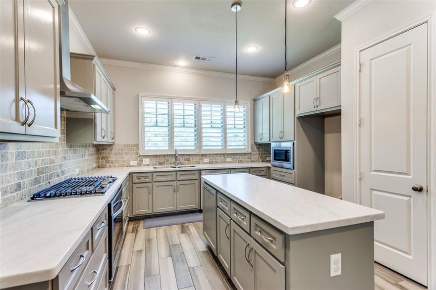 Like New 2 Story Townhome in Desirable Gated River Heights Community has direct access to the Trinity Trails only minutes from Downtown! Each bed has its own private bath. The custom wood door with iron treatment welcomes you into this Village Home with wood like tile throughout. Downstairs find all entertainment space including a grand kitchen with 3 inch leathered granite counter top, a gas stove, built in microwave, stainless whirlpool appliances, walk in pantry and shuttered window wall looking onto the mature landscape. The spacious living room has a built in bookshelf, gas start exposed brick fireplace, and additional flex space perfect for a sitting area. The beautiful French Doors lead to the 17x12 open patio with built in tv case and hot tub pad. The half bath down with pedastal sink is perfect for guest access. Don't miss the study nook and mud room with built in bookcase, granite counter top & custom hardware. Upstairs find all beds, the utility room and an additional 18x7 loft space that could serve as a second office, play room or quiet retreat. The primary ensuite has custom window treatments, a cedar closet, walk in shower w bench & a leathered dual sink vanity with custom tile. The secondary beds are large with spacious closets and each have their own ensuite bath, one with a shower tub combo and one with a walk in shower. Walk to the River District Peninsula shops, enjoy the private community pavilion & park, run or bike along the trails and attend neighborhood events!