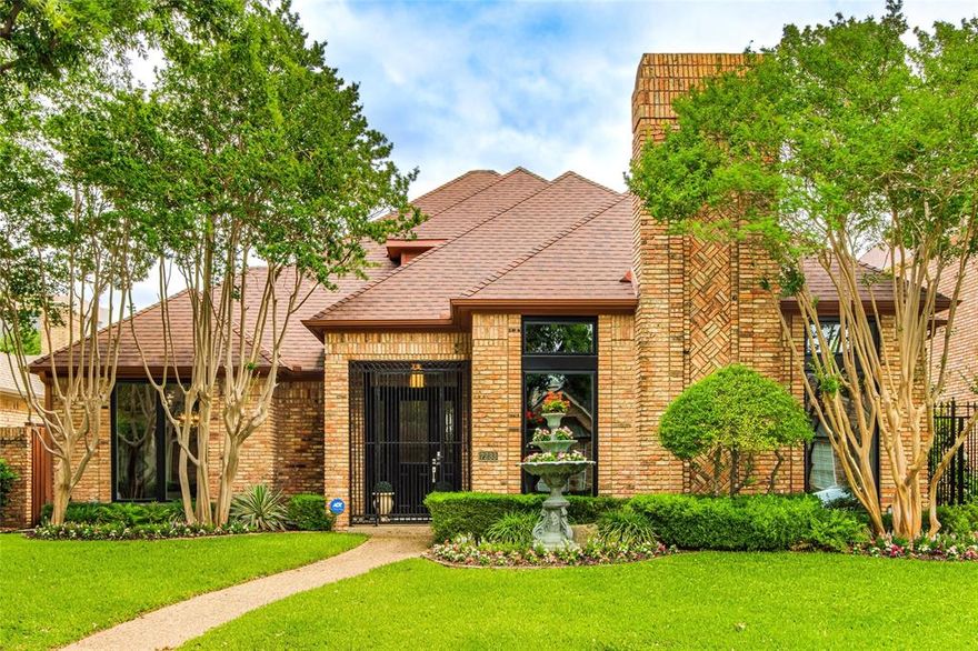 Come Experience this charming, timeless beauty, nestled on one of the premier wooded streets in Waterford on the Park. This secluded neighborhood offers a community pool, walking & jogging path, private lake and tennis court and is ideally located within the LBJ inner loop with convienent access to shopping, dining, hospitals, airports & more.  A Beautiful home offering both convenience and exceptional curb appeal.  From the moment you arrive, you'll be captivated by the lush landscaping, mature trees, and striking windows that create a truly unforgettable first impression. Inside, discover an inviting layout filled with warm, relaxing spaces designed for both everyday living and entertaining in true Texas style. The impressive great room offers the perfect gathering place, while the beautifully remodeled kitchen features a cooktop framed by a stunning brick alcove, cherry wood cabinets, blending character and functionality seamlessly. The charming breakfast area showcases a wall of custom built-ins and opens through French doors to an extraordinary cobbletone patio surrounded by lush greenery and complete privacy-an idyllic setting for quiet mornings or intimate evenings outdoors. The luxurious primary suite is a peaceful retreat, complete with its own fireplace, private patio access, and a beautifully updated spa-inspired bath and custom closet. A versatile front flex space offers endlss possibilities and can easily serve as a second dining area, private office, or additional living space. Throughout the home, you'll appreciate the abundance of storage and thoughtfully designed built-ins. Upstairs, two generously sized bedrooms, and a spacious remodeled bath, provide comfort, and complete this exceptional home. Come see this timeless retreat for yourself and experience the warmth, character, and beauty this home and neighborhood has to offer.