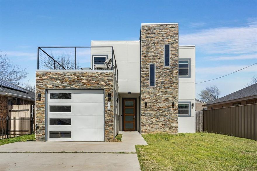 Ideally located just five miles west of downtown Dallas, this 2021 transitional home offers a seamless blend of modern design and everyday comfort. Thoughtfully designed with four spacious bedrooms and two inviting living areas, the home provides a versatile layout perfect for both relaxed living and effortless entertaining. At the heart of the home, the open-concept kitchen shines with sleek quartz countertops, stainless steel appliances, and a casual eat-in dining area creating a natural gathering space for family and friends. High ceilings and luxury vinyl plank flooring enhance the airy feel, while a decorative electric fireplace adds a stylish focal point to the main living area. An EcoSmart tankless water heater brings both efficiency and convenience to daily living. The primary suite serves as a private retreat, complete with a beautifully appointed ensuite bath and an oversized walk-in closet. Three additional bedrooms offer flexibility for guests, a home office, or growing households. One of the home’s standout features is the upper-level garage deck.  An ideal setting for entertaining, relaxing in the sun, or enjoying evening gatherings under the stars. The expansive backyard provides plenty of room for outdoor living, pets or play. All of this, just minutes from downtown Dallas, the Bishop Arts District, Love Field Airport, and the vibrant dining and entertainment of Trinity Groves—offering the perfect balance of convenience and lifestyle.