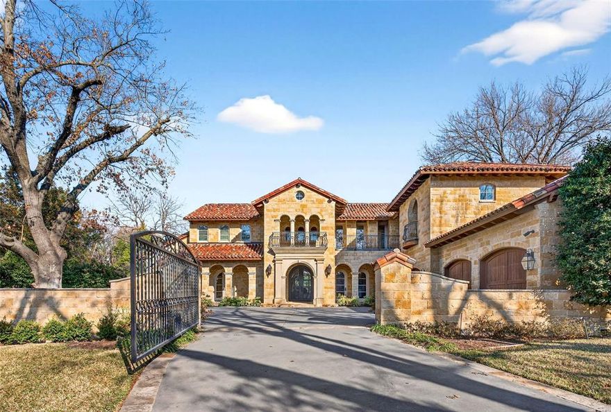 Located on a beautifully landscaped, gated lot of approximately 0.622 acres in coveted Old Preston Hollow, this Mediterranean-style estate offers exceptional scale, privacy, and resort-style living. The expansive 108' x 249' lot features five bedrooms, six full baths, three half baths, and a three individual bay car garage with motor court.

The main level is designed for elegant yet functional living, with an open, flowing floor plan that accommodates both formal entertaining and everyday comfort. Spaces include refined formal living areas, a private library or office, a formal dining room and multiple interconnected gathering rooms.

The gourmet chef’s kitchen serves as the heart of the home, highlighted by dramatic 21-foot ceilings, commercial-grade appliances, an oversized island, and a full bar with a wine room. It opens seamlessly to the keeping room and family room, creating a natural hub for entertaining and daily living.

The first floor includes the primary suite and a guest suite, all with en-suite baths. The primary retreat offers a private sitting room with fireplace, dual spa-like bathrooms, and two expansive walk-in closets. Upstairs, three additional en-suite bedrooms are joined by a large game room with private balcony and a dedicated fitness room.

Outdoor living is a standout feature, with approximately 2,000 square feet of covered spaces, multiple terraces, and two covered patios. The resort-style backyard includes a pool with tanning ledge, spa, fountain, and multiple water features. Heat lamps extend year-round usability in the covered patio, while 12-foot holly hedges provide complete privacy with no sightlines from neighboring properties. This is a rare opportunity to own a private estate in one of Dallas’ most prestigious neighborhoods.