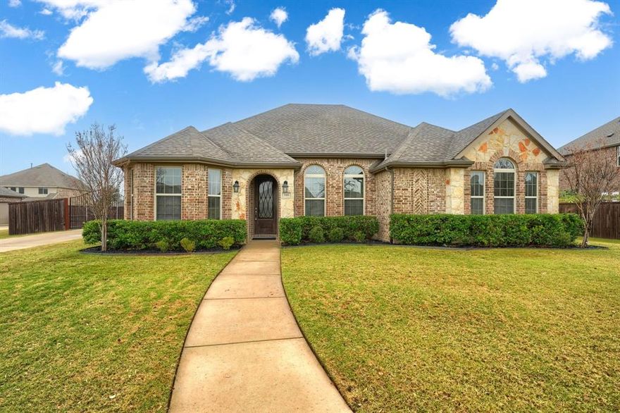 This elegant 1.5 story, 4 bedroom, 2.5 bath home with an office, and a game room gives you all the space you need for the entire family. Stand out features combine vaulted ceilings, decorative lighting, bay windows, and a stunning stone gas fireplace that anchors the living space.  The designer kitchen showcases modern white cabinets, quartz countertops, subway backsplash, SS appliances, and large eat in island. The wood and ceramic tile flooring throughout the home paired with new paint feels warm, inviting, and beautifully finished. The large backyard includes an open patio, a full sprinkler system, and wood fence for privacy.  A huge bonus is oversized side entry garage, paired with an electric gate providing both convenience and an added layer of security!
