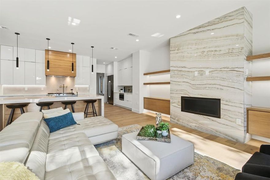 A masterpiece for those seeking a turnkey lifestyle in the heart of Dallas' vibrant Bird Streets. The seamless flow of the expansive living area invites you in, where sleek wood floors, modern lighting, and carefully curated décor create an atmosphere of refined sophistication. At the heart of the home is the contemporary kitchen, equipped with top-of-the-line Jenn Air appliances and complemented by a butler’s pantry-prep kitchen, ensuring every detail is in place for effortless entertaining. Beyond, the formal dining room offers a stunning setting for gatherings, blending elegance with warmth.
The primary suite is a personal sanctuary designed to indulge and inspire. Its spacious walk-in closet connects directly to the laundry room, a thoughtful touch simplifying daily routines. Outside, the magic continues in the private backyard oasis, featuring a sparkling pool and jacuzzi, surrounded by spaces perfect for everything from lively celebrations to peaceful evenings. Every corner of this home has been crafted for a balance of connection and escape, making it an unparalleled retreat.
Upstairs, the story unfolds with a flexible design tailored to adapt to your needs. A spacious loft with a wet bar becomes the ultimate spot for relaxation or hosting, while a comfortable junior suite ensures privacy. Two additional bedrooms offer space for family or guests, while the bonus theater room, ready for movie nights or repurposed as a gym or office, adds versatility. A second laundry room and thoughtful details throughout underscore the home’s blend of practicality and luxury.
Just minutes from Love Field and within walking distance of bars, restaurants, and shops, this is more than a home—it’s a lifestyle. Every detail has been meticulously considered, from the flow of the spaces to the exquisite finishes, offering a truly turnkey retreat in one of Dallas’ most sought-after neighborhoods.  This is where your next chapter begins.