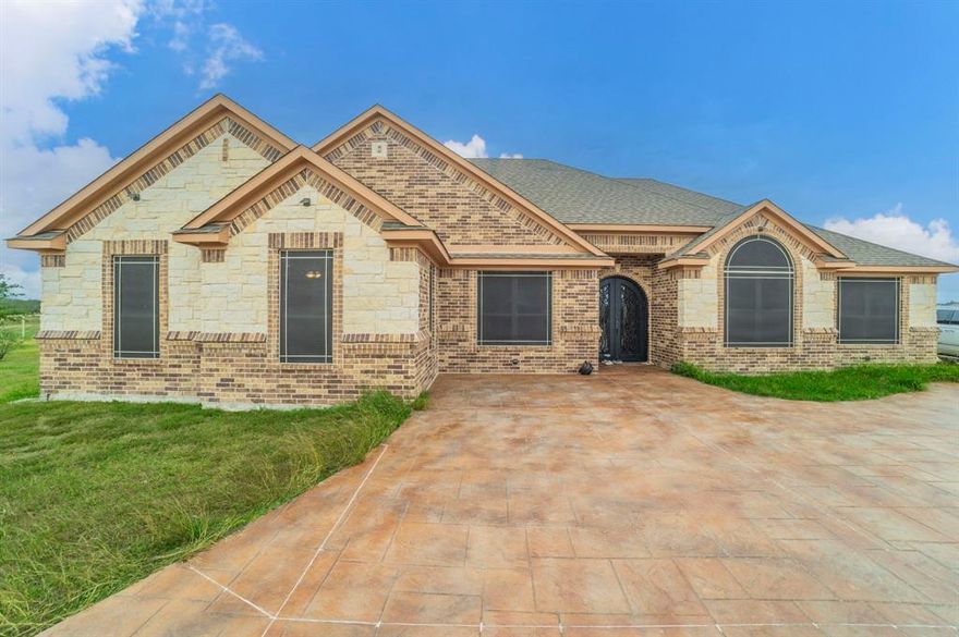 Come take a look at this outstanding Ranch just minutes from historic downtown Ennis and 35 miles south of Dallas. This like new home has
 4 bedrooms, 3 baths, two living areas with exquisite woodburning fireplace in the main area. The flooring throughout the home is engineered wood, and tile. The kitchen has granite countertops, stainless steel appliances, and large breakfast room makes this of the home a place you will spending time in. The home is located on a ridge with visibility to the entire beautiful 12 acres.
The circle driveway is stamped concrete with a section that goes down the side of the home to the covered back porch which is a great place for evening gathering.