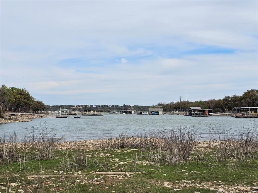 Build your dream home on this beautiful half-acre waterfront lot located on scenic Lake Brownwood in the desirable Feather Bay subdivision. This property offers the perfect blend of natural beauty and resort-style living, featuring mature oak trees that provide shade, character, and a peaceful setting right by the water.

Enjoy direct lake access and the tranquility of waterfront living, whether you’re looking for a weekend retreat or a full-time residence. As part of the community, you’ll have access to The Hideout Golf Resort, where amenities include a championship golf course, swimming pool, on-site dining, RV hookups, and more—perfect for relaxing or entertaining family and friends.

Conveniently located just a short drive from Brownwood, you’ll have quick access to shopping, dining, and everyday essentials while still enjoying the privacy and charm of lakeside living. Don’t miss this opportunity to own a slice of Texas waterfront paradise.
