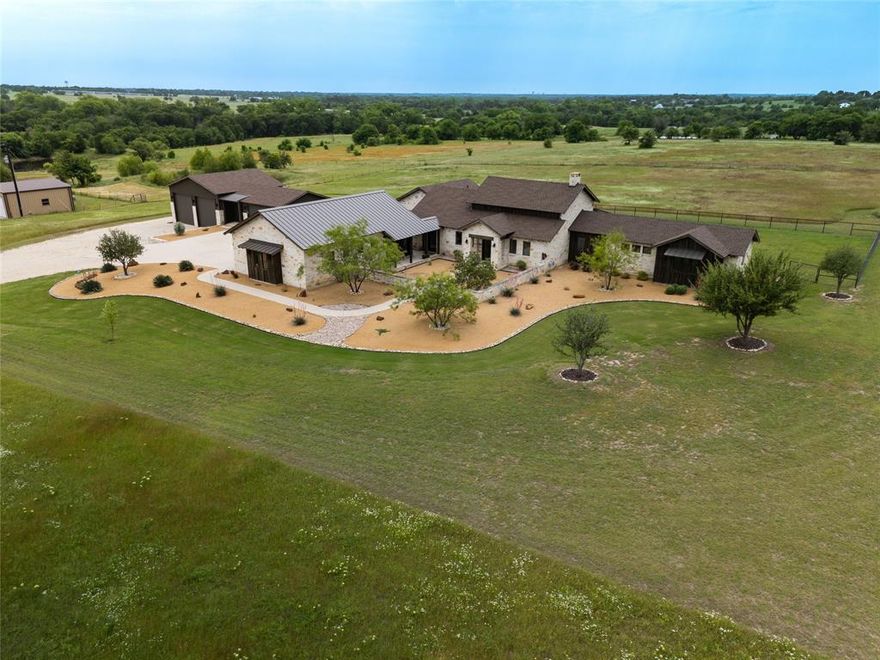 HILLTOP LUXURY WITH PANORAMIC COUNTRYSIDE VIEWS - Perched high above the road on 10 private fenced ag-exempt acres, minutes from Lake Ray Roberts. This gated custom 2,730 sq ft home was thoughtfully designed in 2020 by the owner-builder to capture sweeping panoramic views of the rolling countryside. Set back on a gentle hill, the property offers both seclusion and serenity in a setting reminiscent of the Texas Hill Country’s natural beauty. Inside the home features 3 spacious bedrooms, 2.5 baths, a dedicated study and a three-car oversized garage. The open-concept layout centers around a chef's dream kitchen complete with a large granite island, 5-burner range, dual ovens (gas and electric), a wine fridge, and a separate beverage fridge. With a blend of modern and hill-country style design, every detail of the home reflects style and functionality. Native, drought-tolerant landscaping surrounds the property, while outdoor living spaces, like the fire pit, invite you to relax and take in the sunsets. For the craftsman or hobbyist, the estate includes: A large shop with an epoxied floor - perfect for auto projects, woodworking, or your next creative pursuit. Additional space with 12’ overhead doors for equipment and tractor storage. Space for an RV up to 35 feet. Built with energy efficiency in mind, the home features high-performance appliances, 6-inch walls, engineered hardwood floors, spray foam insulation, Navien tankless water heating system and other energy-saving systems to keep utility costs low. Don't miss this rare opportunity to own a truly special hilltop retreat that blends luxury, practicality and endless views. PLEASE SEE DOCUMENT STORAGE FOR FURTHER INFORMATION & PROPERTY NIGHTTIME PHOTOS. PROOF OF FUNDS REQUIRED FOR ALL SHOWINGS.