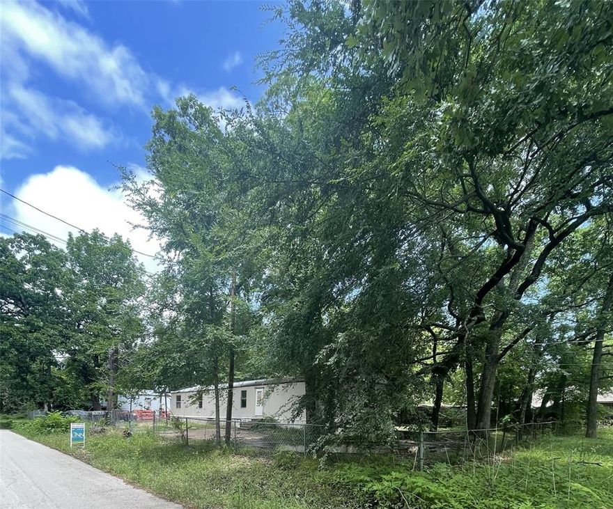 0.2932 acre lot with nice trees. Property currently has a singlewide home on it. Not aware of the condition of the home. Home could be removed or possibly fixed up.
