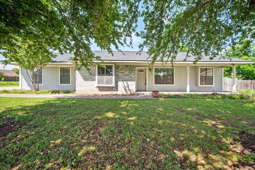 Charming 3-Bedroom Home Near Lake Dallas! This spacious 3-bedroom, 2-bathroom home offers flexible living with two living areas, a large game room, and an open floor plan perfect for entertaining. Gorgeous wood floors flow through the main living areas, while a corner fireplace with a custom oak mantle adds warmth and character. The open kitchen features stainless steel appliances and overlooks the living room, making it the heart of the home. The primary suite is a private retreat with recently replaced carpet, a window seat, walk-in closet, frameless glass shower, and a relaxing garden tub. Enjoy the outdoors in the landscaped yard, complete with a greenhouse for garden enthusiasts and a detached garage with attic storage. Located near Lake Dallas, you'll love the easy access to nature, while still being close to shopping, dining, and commuting routes. Fixer Upper, priced to sell as is