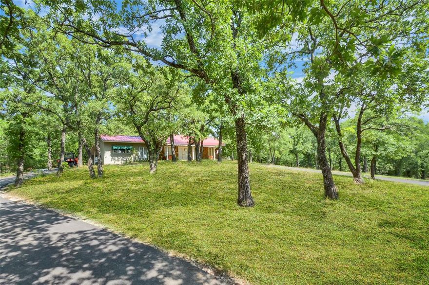Set on more than eight acres, this North Texas retreat blends wide-open spaces with timeless ranch character. A private electric gate and a winding drive lead through pipe-rail fencing and cross-fenced pastures of sandy loam soil to a single-story ranch home tucked beneath mature trees at the crest of a hill.
The 1,800-square-foot residence is perfectly positioned to overlook the land, with wooded areas, open pasture, and a stock pond visible from the nearly 40 foot wide front covered porch. Just below, the barn offers multiple stalls, a corral, and even a ranch hand apartment, supporting both equestrian and agricultural pursuits with ease.
An existing agricultural exemption and the absence of city taxes add financial advantages to the property, while the surrounding environment enhances its lasting value—neighboring multi-acre tracts and undeveloped Corps of Engineers land across the road provide built-in privacy for years to come.
Location is another highlight. Only five miles from Denton, 2.5 miles from shopping and dining in Cross Roads, 11.5 miles from the PGA of America’s Frisco headquarters, and just minutes from Lake Lewisville, the estate offers a rare balance of seclusion and convenience.
For those seeking expanded possibilities, additional acreage is available—including a barn, pond, and a 6,500+ square-foot luxury executive estate (MLS 21073173).