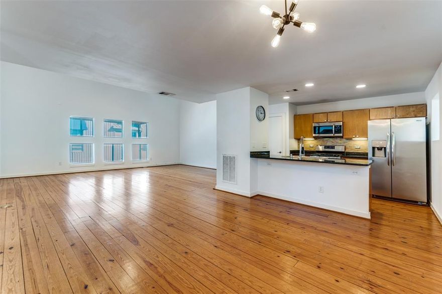 NEW PRICE! Bring your buyers to this spacious 2 bed, 2 bath, plus office or flex space townhouse with 2 car garage. Fantastic location minutes from Downtown Dallas and Baylor Medical Center. Abundant natural light, welcoming floorplan, serene tree-lined back courtyard make this Swiss Avenue townhouse the perfect mix of urban living and neighborhood charm.  Open-concept is ideal for both entertaining and relaxing featuring a spacious living room, dining area and kitchen with granite counters and large peninsula with counter seating.  Pine plank flooring, dramatic two-story vaulted ceilings and plentiful natural light add to the ambiance of the living spaces.  Living area includes access to a small balcony in front and a second larger balcony overlooking the private back courtyard, perfect for morning coffee or an evening beverage.  First floor entry level includes a private guest bedroom and full bath, full-sized laundry area, direct access to the two-car garage and private back courtyard, PLUS a bonus room for an office, gym or lounge.  Continue upstairs to the third level where the primary suite features new carpet, vaulted ceiling, a large walk-in closet, ensuite bath with 2 sinks, dual shower heads and soaking tub, and perfect niche for a cozy sitting area or desk.  The primary bedroom has large windows to bring in light and tree views for a natural serenity.  Few properties have outdoor space that compares to this townhouse with its beautifully shaded large back courtyard.  There is an 8-foot wood privacy fence and the possibilities for entertaining or creating your own garden oasis are unlimited.  While you may not want to leave your Swiss Avenue sanctuary, when you do, you have unparalleled access to Dallas’s finest attractions and amenities living minutes from the Arts District, Downtown, Uptown, Lower Greenville and Deep Ellum. Outdoor enthusiasts will appreciate the Katy Trail, Exall Park, Bryan Place Community Pool and White Rock Lake.