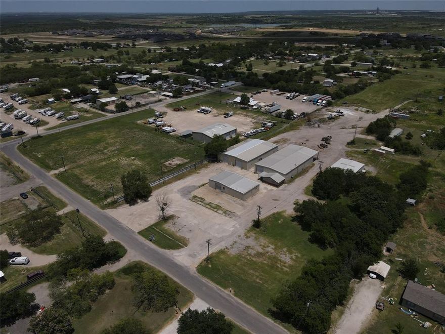 Property is South of Hwy 287 and west of Hwy 67 by 1.5 miles either direction. Established warehouse and shop space ready to meet industrial demands with multiple water meters and 3 phase power. On Site water well to meet any additional water demands. Approximately 17,500sf of warehouse and 1,200sf of office on 9.8 acres. Outside city limits with no restrictions or zoning requirements. The office space is approximately 1,200sf with three bathrooms, a break room, executive and open office space. 12x16 lounge space designed for contractors or drivers. The yard is fenced with iron pipe gates. Over two acres of improved yard with materials on site to expand. Plenty of room for future growth with +or-6 acres undeveloped. Strategically located in a strong, densely populated submarket of Dallas-Fort Worth, with persistent growth and construction in the immediate vicinity. development of retail and restaurants, new housing, along with industrial production is steadily drawing more attention to this area over the years, a statement on the strategic opportunity.