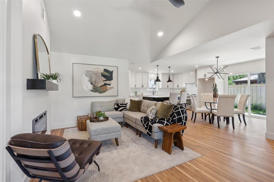 Fully reimagined from the foundation up, this move-in ready 4-bedroom, 2.5-bath home sits on a generous 0.25-acre corner lot in one of Dallas' most exciting up-and-coming areas. Every detail has been thoughtfully updated and the open-concept living space is filled with natural light and features dramatic vaulted ceilings with a wood beam detail, luxury vinyl plank flooring, and an electric fireplace with custom mantle. The kitchen is equally impressive with quartz countertops, custom cabinetry, stainless steel appliances, designer lighting, and a large island perfect for gathering. The oversized primary suite is a true retreat complete with a wall of windows, a spacious walk-in closet, and a luxe ensuite bath featuring a double vanity, built-in linen storage, and a stunning wet room with soaking tub and glass-enclosed shower. Three additional bedrooms offer plush carpeting and ample closet space, while the updated hall bath includes a double vanity and modern finishes. A two-car attached garage adds everyday convenience, and the expansive fenced backyard is ideal for outdoor entertaining, play, or gardening. Recently added irrigation system makes for easy lawn care.  Located in a neighborhood on the rise, this property blends turnkey style with long-term value.