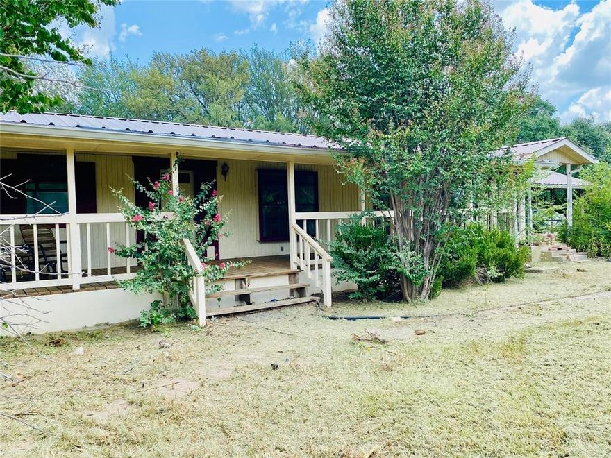 A True Diamond in the Rough – with Space, History, and Endless Possibilities. Step into a property unlike anything else on the market. This sprawling 3+ bedroom, 2 bath home offers over 2,400 sq. ft. of living space and a layout that invites creativity at every turn. Built by surveyor Charles Polaski, this home carries history and character, with a separately metered detached office building that once housed his workspace.
 Six separate exterior doors create a seamless connection between indoor living and the outdoors. The front acre is fenced, mostly cleared, and dotted with mature shade trees, garden spaces, and even a chicken coop - perfect for your own mini homestead. A covered front deck spans the home, with two entrances each revealing a different facet of this unique floor plan. The original layout housed a formal parlor with stained glass - once a refined sitting room, later a cheerful playroom, and easily transformed into a bedroom, office, or art studio. 

Multiple dining areas connect from the kitchen with two separate buffet or bar seating areas and flexibility for entertaining or large family gatherings.
There are thirteen rooms total - nine of which are flexible in use to create whatever layout fits your lifestyle.

Beyond the house, the property stretches to round out nearly 5 acres, with wooded trails leading to a wet-weather creek and a fenced back pasture - ready for clearing to welcome livestock or even an additional building site. Gardens areas created in both the front and back yards, with plenty of space to grow your vision.

Yes, the home needs love - flooring, cosmetic updates and repairs, but it’s got great bones. Metal roof, new HVAC with Nest, and lateral lines all updated within the past within the past 2 years. For someone with vision, the payoff will be extraordinary. Flexible spaces and a private acreage setting combine to create a once-in-a-lifetime opportunity to restore something truly special.