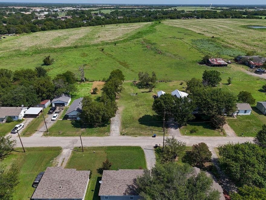 2501 McFarland, Caddo Mills, TX 75135 is a spacious, improved lot in a mature, quiet neighborhood. Utilities on site include an established water meter, city sewer, electricity, and natural gas. Zoned in Caddo Mills ISD, recently backed by a 90 million dollar bond for a new high school and campus upgrades, this parcel offers easy access to I-30 and SH-66 for direct commutes to Dallas, nearby shops, restaurants and services with additional retail developments underway, a 50-acre commercial and multifamily project planned at IH-30 and FM 1565, and placement in a community slated for 11,000 new homes and significant population growth. Ready for residential construction, this lot combines essential infrastructure with strong school, highway, and amenity access in a rapidly expanding market.