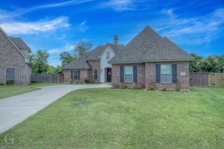 This charming North Bossier home is ready for its new owners! Situated on a 0.3-acre lot with no rear neighbors and impressive curb appeal, it’s located in Cattail Point within the Legacy Community. The open floor plan features 5 bedrooms and 3 bathrooms, offering plenty of space and comfort. Notable details include brick accents and exposed beams in the living room, tray ceilings in the master suite, stunning granite countertops throughout, rich hardwood floors in the main living areas, a convenient mud bench by the garage entrance, extra storage in the kitchen island, and a centralized utility room with a dedicated pet shower. Two fireplaces add warmth—one in the living room and another on the back patio. The front of the home highlights a charming courtyard-style patio. Outside, enjoy a spacious covered patio, an above-ground pool, an extended back deck, and a fully fenced yard with elegant wrought iron fencing. The community offers stocked ponds, walking and biking trails, common green spaces, and a pool. This home qualifies for Rural Development.