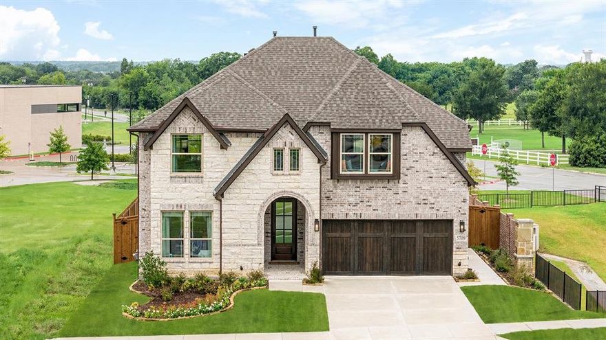 FORMER MODEL HOME! Crafted by Bloomfield Homes - Never Lived In, Professionally Designed, and Premium Landscaped Homesite! The 'Violet IV' plan has tall ceilings, 5 bedrooms, 4 baths, a game room with attached media room, and charming back covered patio. Beautiful curb appeal on a corner lot that backs to the elementary school and sides to a greenspace. Contemporary stylings inside include wide-plank engineered wood floors, lightly stained Shaker cabinets (and painted white along the walls in the kitchen), white quartz and granite countertops, a polished tile-to-ceiling fireplace with a floating box mantel, a wood starter step, and horizontal railing at the stairs and the upstairs overlook. Windows keep the home bright all day long, and the custom drapes come included in the sale of the home! Also staying with the home are the window seat cushions and all the kitchen's stainless steel appliances. The first floor is home to two of the bedrooms - the primary suite and a guest room with a full bath just outside the door! The primary has a versatile tan and navy color combo, and the bathroom provides you options with a bench-seat shower and separate tub. Storage was placed at every opportunity, from an under the stairs closet to the laundry room with a built-in mud bench. Upstairs hosts a central game room flex space and cozy media room. One bedroom suite is separated from the other 2 bedrooms that share another full bath. Outdoors can be enjoyed from a shaded spot under the covered rear patio. Accent paint is done, sprinkler system is installed, a side entrance to the garage already added... There's a lot more to love when you buy a former model home! Open daily for you to tour during business hours - see the home fully staged to experience the home's full potential!