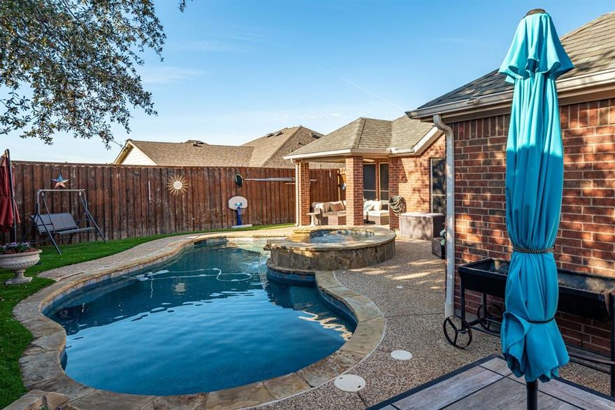 PRICE IMPROVED!!! 2.75 Assumable rate available! Nestled in the desirable Carter Ranch community, this exquisite First Texas–built residence offers a thoughtfully designed floor plan featuring five bedrooms, three and a half baths, and an abundance of upscale finishes throughout. From the moment you enter, you are greeted by a grand foyer flanked by a formal dining room and a private study, setting the tone for both gracious entertaining and everyday living. The home showcases a desirable split-bedroom layout with three generously sized secondary bedrooms and a beautifully upgraded full bath. The expansive living area is highlighted by a gas or wood-burning fireplace and flows seamlessly into the chef’s kitchen, which boasts granite countertops, abundant cabinetry, ample prep space, and stainless steel appliances. The secluded primary suite is a true retreat, featuring an oversized bedroom with its own gas fireplace and a spa-inspired en-suite bath complete with a soaking tub, standalone shower, and an impressive walk-in closet. Upstairs, an oversized second primary with a full bath and plenty of storage. Flexible space could be gameroom or workout space. Step outside to your private backyard oasis, where an inviting in-ground swimming pool, ample green space for pets or play, and a covered patio create the perfect setting for relaxing and enjoying sunset views. Ideally located within walking distance to the elementary school, parks, and scenic ponds, and offering convenient access to Preston Road, the Dallas North Tollway, and the Collin County Outer Loop, this exceptional home combines elegance, comfort, and convenience.