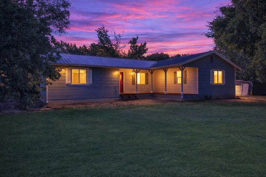 Seller is willing to give a $5,000 closing cost credit! FULLY RENOVATED MOVE-IN READY! Stunning 3-bed 2-bath home sits on a spacious 1-acre lot & has been taken down to the studs, rebuilt with nearly every inch brand new. Attention to detail & extensive updates throughout.  Step onto the charming covered front porch that wraps around 2 sides of the home. Inside is an open-concept living & kitchen space. Kitchen boasts white cabinetry, blue-gray eat-at island, white subway tile backsplash, undermount stainless steel sink, stainless steel appliances, including a built-in microwave. A cozy built-in desk nook with matching granite & cabinets offers the perfect home office or homework station. Laundry room is fully equipped with upper & lower cabinets and room for full-size appliances.  Private primary suite features 2 closets, a stylish en-suite bathroom with a shower. On the opposite side of the home are 2 spacious bedrooms and a full hall bath. The home features 1,514 sqft of beautifully redesigned living space. It's been leveled with some support beams replaced, all new subflooring installed & updated with a brand-new 4-ton HVAC system with heat pump, new electrical panel box, new thermostats, new ceiling fans, lighting, outlets, AC vents. Enjoy new double-pane windows, fresh sheetrock & new laminate wood flooring throughout. The old popcorn ceilings are gone & replaced with clean, modern finishes. Every door—inside & out is new & both bathrooms have been fully updated with new vanities & fixtures.  Exterior improvements include: new paint, new gutters, fresh gravel driveway, new front-side-rear porches, and partial new siding. The metal roof is roughly 8 years old and in great shape. The land is a blank slate ready for your vision, plenty of space to add a shop, pool, garden, or let pets roam & kids play.  If you're looking for a completely remodeled, move-in-ready home with modern updates and country charm, this one checks all the boxes.