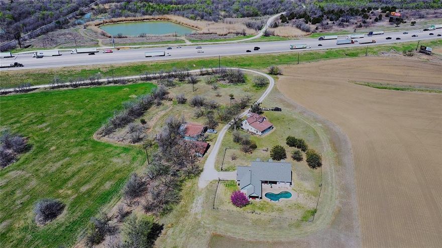 Available for sale for the first time since the 1940s, this 200+ acre farm has all you need for current and potential income. Located on the northbound side of I-35 South of Hillsboro, this property has more than 700 feet of road frontage, 3000+ feet of Union Pacific railroad frontage, and is located in the Hillsboro extra-territorial jurisdiction (ETJ).

The home is a 3 bedroom, 2 bathroom, 2 car garage split floor plan setup with high ceilings and a luxurious pool. Relax and enjoy the sunset’s peaceful reflection in the clouds or get up early for the sunrise. The 190 acres in cultivation provide you with passive income from the tenant farmer or a blank canvas to implement your vision. 

There are two ponds on the property, one measuring 0.6 acres in size and another measuring almost 2 acres in size. The first pond is stocked with catfish and bluegill perch and the larger pond is stocked with catfish and bass. In addition to the ponds, there are wooded nature areas at the back of the property.

With this property, you’ll be conveniently located 30 minutes from Waco, an hour from Fort Worth or Dallas, and two hours from Austin. You’re also close to two lakes - Lake Aquilla and Lake Whitney - for fishing, boating, camping, RVing, and so much more. Imagine the possibilities and contact us for more information.