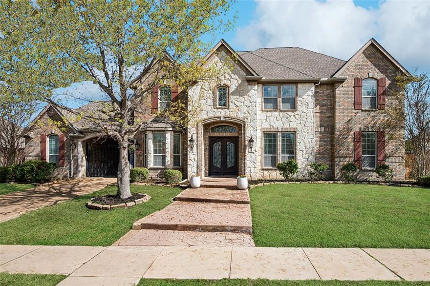 K Hovanian Custom Home located in prime location with exemplary schools. Beautiful curb appeal with secured gated iron and stone entry. Stately entry featuring stone pavers and lush landscape leading to the double iron front entry custom doors. This beauty features a selective neutral marble and wood flooring through out most of the home. Magnificent wood and iron staircase with built in custom lighting, sets the tone for elegance although relaxed feel. The house features an open floor plan with many custom built ins providing many additional features. Master bedroom and secondary bedroom, and or home office, are on first floor making it the desirable floor plan for in law suite or home office.  Dream kitchen with commercial grade cooktop , custom wood cabinetry, large kitchen island and WALK IN MEGA PANTRY.  Master to rear of home with sitting area and dual fireplace open to master bath retreat. Two large living and dining rooms are both open concept to the home, providing natural light and great views of the Texas sky. The custom wall of windows in downstairs living overlook the large corner private lot, and the second story of the home also provide incredible views of the over quarter of acre yard and space.  Two staircases lead to the upstairs in which all bedroom are over sized and with ensuite or jack and jill baths. The game room featuring hardwood flooring and builtins provides great entertainment and very open to the first floor of the downstairs. Private movie theatre in which all equipment conveys.  The back patio features a motorized louvered pergola with extended patio. Night Owl CCTV security with 8 wired cameras and two monitors conveyed with home.